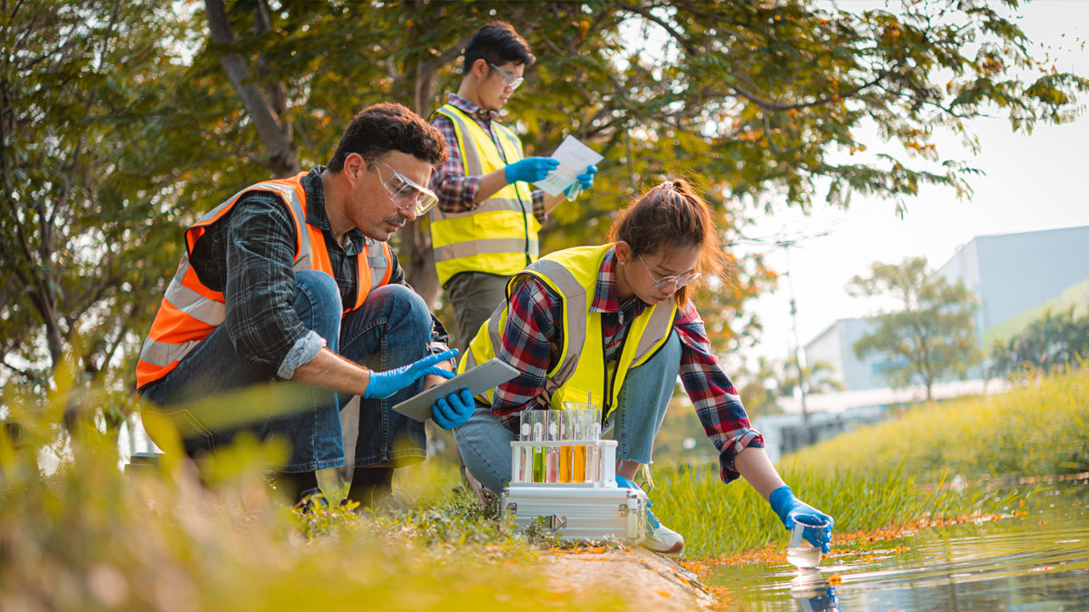RIT students take samples from a pond near campus.